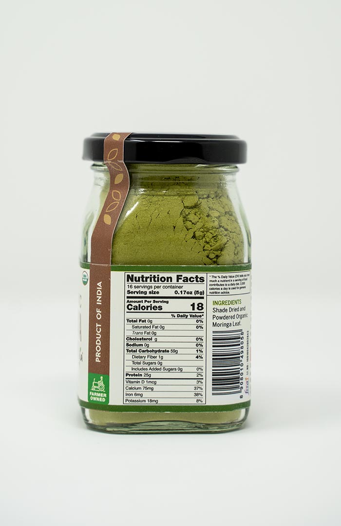 Pure moringa powder in a glass bottle, farm-produced organically by Ishka Farms