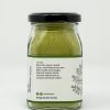Pure moringa powder in a glass bottle, farm-produced organically by Ishka Farms